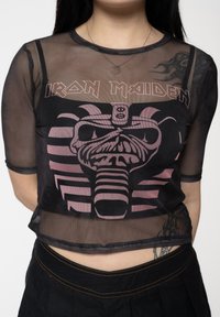 Black mesh cropped top with short sleeves, featuring a pink Iron Maiden graphic design, round neck, and visible stitching details.