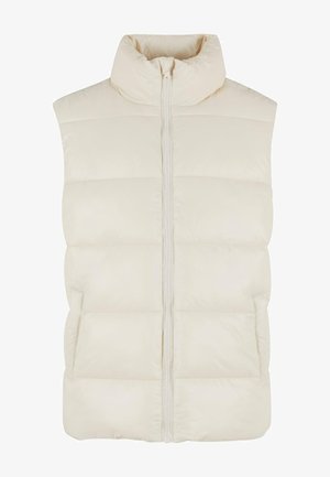 Chaleco acolchado de color crema con cuello alto, cremallera frontal y bolsillos laterales. Presenta paneles acolchados para aislamiento y un acabado suave.