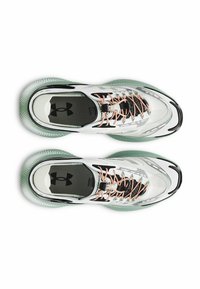 Zapatillas deportivas blancas con parte superior translúcida y suela verde, con detalles en negro, cordones naranjas y un logotipo prominente en la lengüeta.