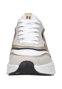 Sportliche Sneaker mit einem Obermaterial aus weißem Leder, beige und schwarzen Suede-Akzenten, flachen weißen Schnürsenkeln, goldenen Logo-Details und einer dicken schwarzen Sohle.