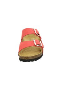 Coral-colored slide sandals with two adjustable straps, silver buckles, and a textured footbed. Thick black rubber sole for grip.