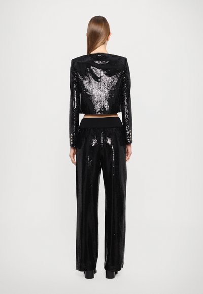 Black sequin jacket and pant set, featuring a cropped jacket with long sleeves and slim-fit trousers, both with a glossy texture and sheen.