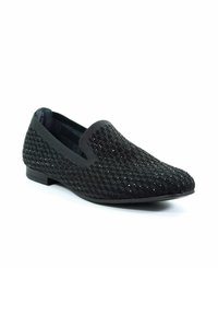 Scarpa nera slip-on con tomaia in rete testurizzata, caratterizzata da un motivo a incrocio e leggere scintillii, suola piatta e bordi elasticizzati.