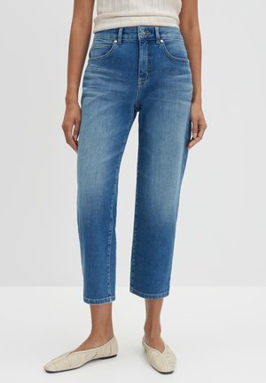 Light blue denim jeans with a high waisted fit, cropped length, five pockets, and subtle fading. Paired with cream flat shoes.