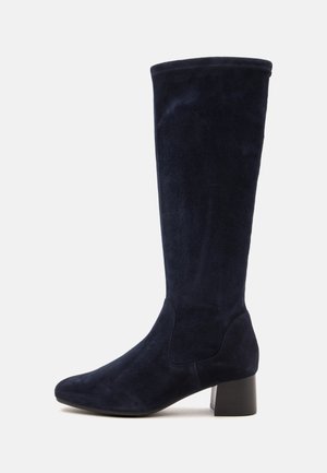 Tall black suede boot with a low block heel and rounded toe, shown from the side on a white background.