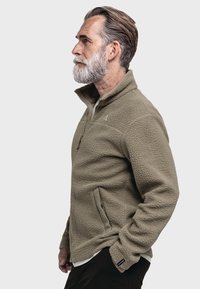 Fleecejacke in Olivgrün mit einem Reißverschlusskragen und Seitentaschen. Strukturierter Stoff mit einer weichen, angerauten Oberfläche.