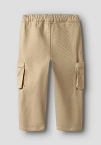Beige cargo shorts made of textured fabric, featuring an elastic waistband and two side pockets on the legs.