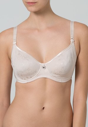 Beige bh met gladde cups met een cirkelpatroon, verstelbare bandjes en een kleine decoratieve accent in het midden vooraan.