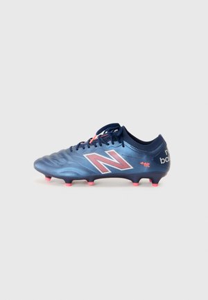 Blue football boot with textured surface, pink studs, and white "N" logo. Features laces and a padded collar for comfort and fit.