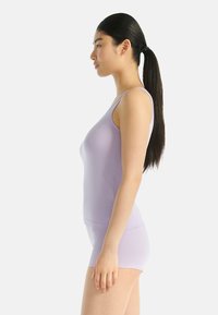 Purple tank top and matching shorts made of stretchy fabric. Form-fitting design with thin straps and a smooth texture.