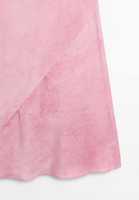 Soft pink fabric with a diagonal seam and slight texture, creating a smooth and flowing draped appearance.