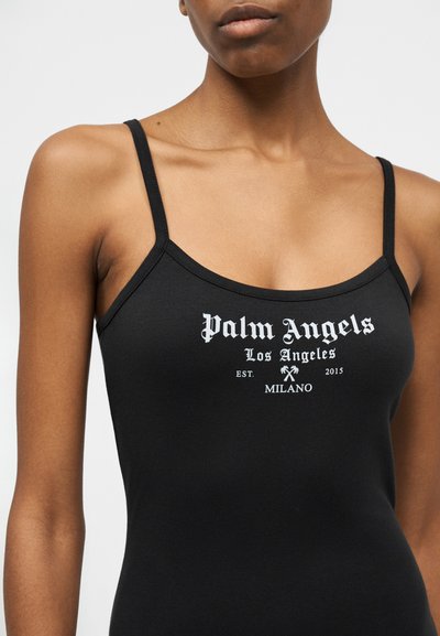 Black spaghetti strap top worn by a person with "Palm Angels Los Angeles EST. 2015 MILANO" printed in white on the chest.