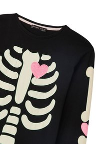 Czarna koszulka z długim rękawem z nadrukiem świecącego w ciemności szkielety oraz błyszczącego różowego serca na piersi. Wykonana z miękkiej bawełny, luźny krój.