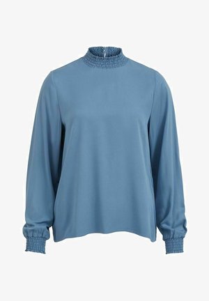 Sininen pitkähihaisen paita, jossa on korkea rypytetty kaulus, kerätty hihansuu ja rento mitoitus. Silkkinen pinta, minimalistinen muotoilu. Takana vetoketjukiinnitys.