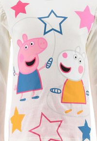White long-sleeve t-shirt featuring colorful cartoon characters. Pink and blue stars printed, with Pig and Rabbit designs in vibrant colors.