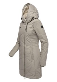 Light beige, full-zip winter coat with a large hood, quilted texture, side pockets, and a black accent circle on the sleeve.