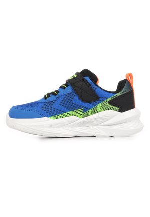Blue children's sneaker with black velcro strap, green accents, white sole, and orange pull tab on the back, shown in side profile.