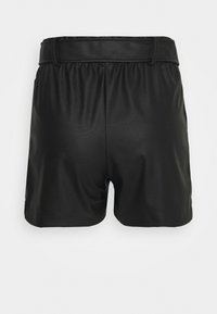 Shorts en simili cuir noir avec une taille élastique, présentant une texture lisse et une coupe décontractée, se terminant juste au-dessus de la cuisse.