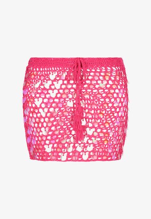 Gehaakte rok in felroze met reflecterende ronde sequins. Voorzien van een koordsluiting in de taille en een franjesdetail. Open geweven ontwerp.