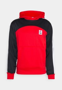 Sweat à capuche rouge et noir avec une poche avant, une capuche, et un patch logo Nike. Présente une texture lisse et des manches longues avec des accents blancs contrastants.