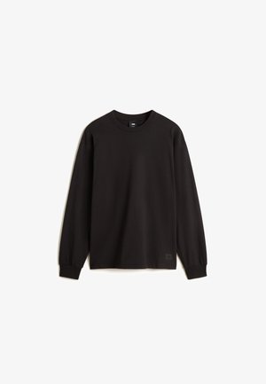 Czarny długi rękaw T-shirt z gładkiego materiału, z okrągłym dekoltem i mankietami. Mała metka z logo na dolnym lewym krańcu.