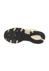 Suola di scarpa in gomma nera con accenti crema; presenta un motivo di battistrada testurizzato e profonde scanalature per la trazione. Fa parte di un design di scarpe da corsa.