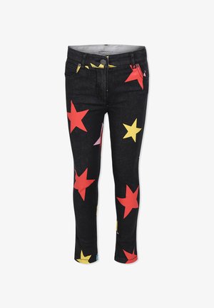 Jeans in denim su sfondo nero con motivi di stelle colorati in rosso, giallo e rosa. Design aderente con vita di media altezza.