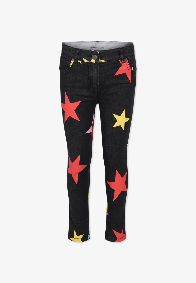 Jeans in denim su sfondo nero con motivi di stelle colorati in rosso, giallo e rosa. Design aderente con vita di media altezza.