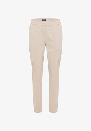Pantalon cargo beige léger avec taille élastique, poches latérales à rabat et poignets élastiques à la cheville.