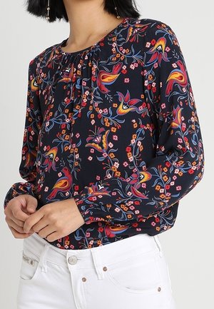 Langarmblouse van donker marineblauw stof met kleurrijke bloem- en vogelpatronen, met een verzamelde halslijn en een ontspannen pasvorm.