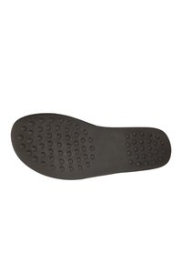 Black rubber shoe sole featuring a smooth surface with circular grip patterns and rounded edges for enhanced traction.