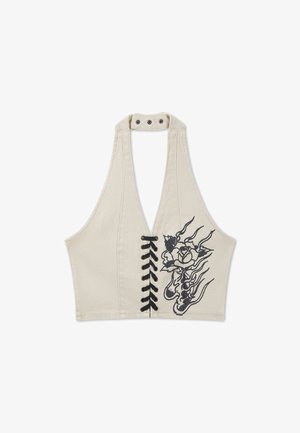 Beige halter crop top met zwarte veter aan de voorkant en zwart bloemenvlammotief aan de rechterkant.