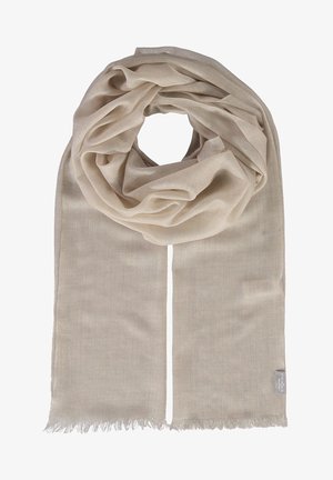 Sciarpa beige realizzata in tessuto leggero, con una texture morbida e bordi frangiati, disposta a loop con estremità pendenti.