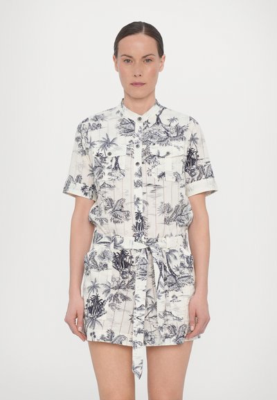 Short-sleeve shirt dress in light fabric with a palm tree pattern, buttoned front, two chest pockets, and a tied waist detail.
