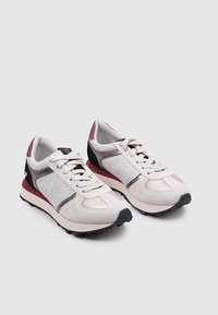 Baskets en gris clair et rose, avec un mélange de matières textiles et synthétiques. Bout rond, fermeture à lacets à l'avant et accents à motifs.