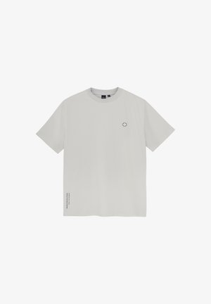 Light gray t-shirt made of soft fabric, featuring a round logo on the chest and subtle text detail on the side. Short sleeves and crew neck.