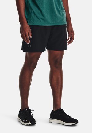 Black athletic shorts with a smooth texture and an Under Armour logo on the left side. Paired with black running shoes featuring a white sole.