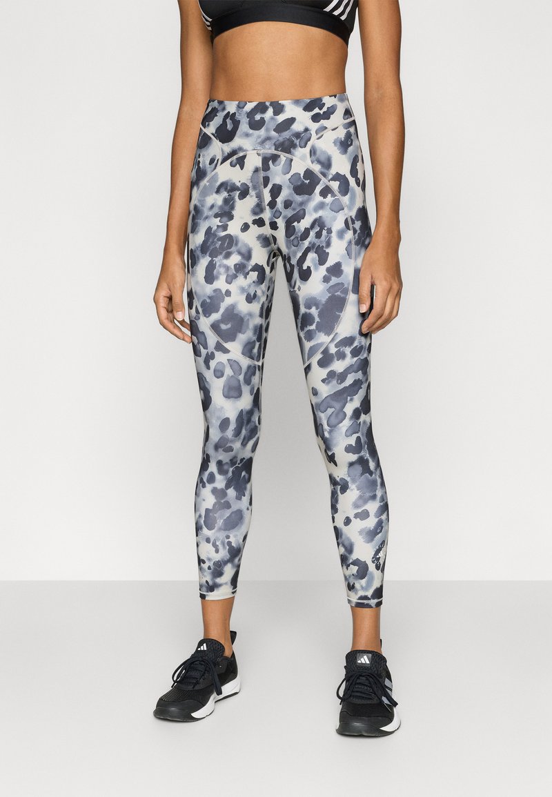 Leggings featuring a blue and gray animal print design, high-waisted, with a stretchy fabric and smooth texture.