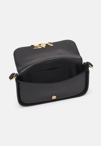 Sac en cuir noir avec une texture lisse, doté d'un fermoir en métal doré et d'un intérieur spacieux avec une poche plate.