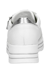 White leather sneaker with silver metallic accents at the heel, textured surface, and a thick white sole with horizontal stripes.