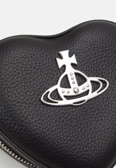 Geantă din piele neagră în formă de inimă, cu un emblema metalică argintie ce are un design cu un planetă și o coroană, accentuată cu detalii rotunde mici.