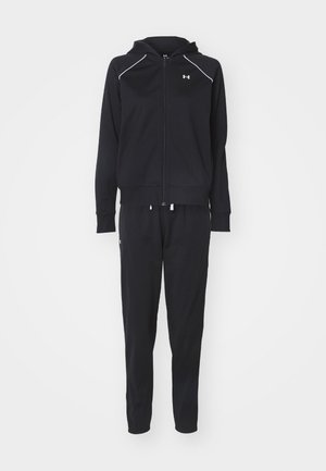 Black athletic tracksuit featuring a zip-up hoodie with white accents and matching tapered pants with an elastic waistband.
