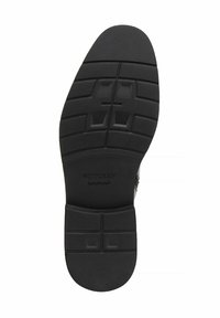 Suela de zapato de goma negra con patrones texturizados, que incluyen rayas y surcos. Presenta la marca grabada "WITTCHEN handmade" cerca del talón.