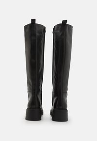 Knee-high black leather boots with a smooth texture, vertical stitching, and a sturdy sole. Features a zipper on the inner side and pull tab.