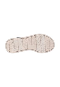 Suela de zapato beige claro con un patrón texturizado de margaritas. Presenta estrías elevadas y un logo en relieve, que proporciona tracción y agarre.