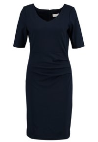 Marinblå klänning i figursydd modell med V-ringning, korta ärmar och sidofållningar. Tillverkad av ett smidigt och stretchigt tyg; dragkedja på baksidan för stängning.
