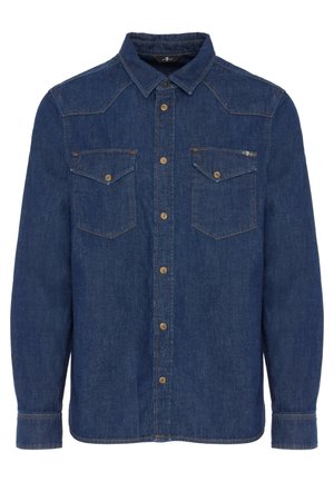 Blå denimskjorte med spidse kraver, to brystlommer, frontknaplukning og kontrastsyninger. Lange ærmer med knapmanchetter.