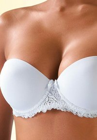 White strapless bra featuring smooth cups, lace trim at the base, and a decorative bow at the center. Soft fabric with a sleek finish.