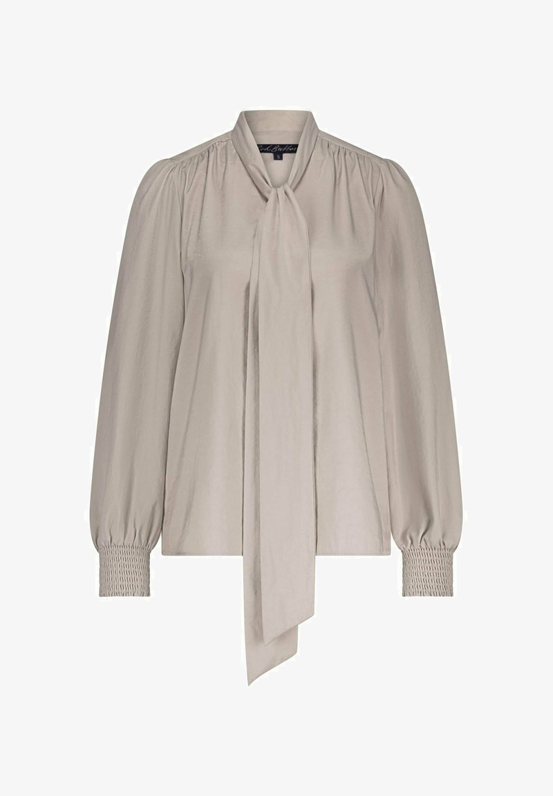 Silky beige blouse with long puff sleeves, tie-neck detail, and smocked cuffs; features a smooth texture and relaxed fit.