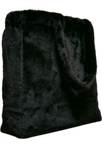 Schwarze Taschen aus Kunstfell mit quadratischer Form, kurzen Griffen und einer weichen, strukturierten Oberfläche. Nahtloses Design ohne sichtbare Beschläge.